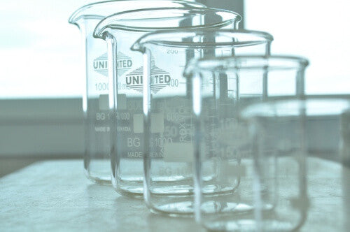 Clear glass beakers lined up all in a row